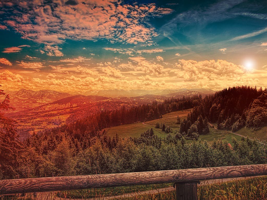 Beautiful mountain landscape with a forest at sunset, vibrant sky and scenic views.